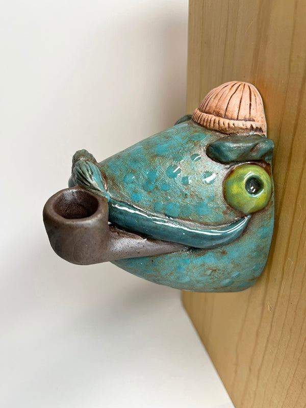 Marty fish-head wall-hanging with peach beanie and pipe