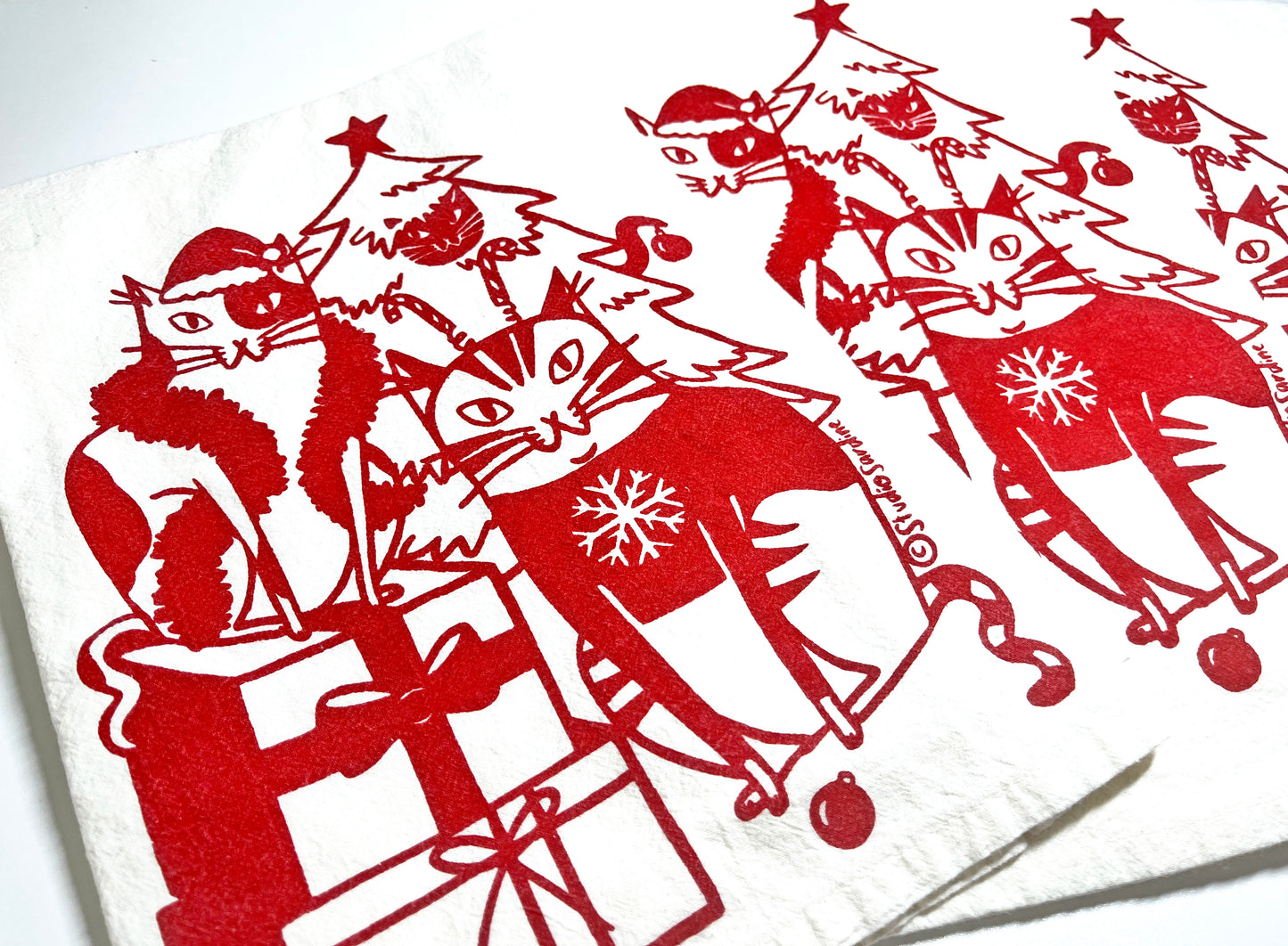 Festive Felines hand-printed tea towel in merry red