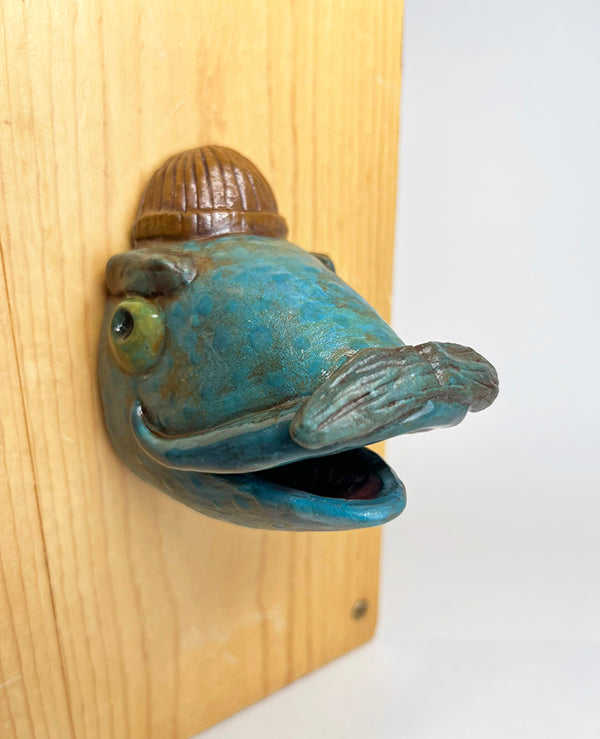 Gus fish-head wall-hanging with tan beanie and mustache