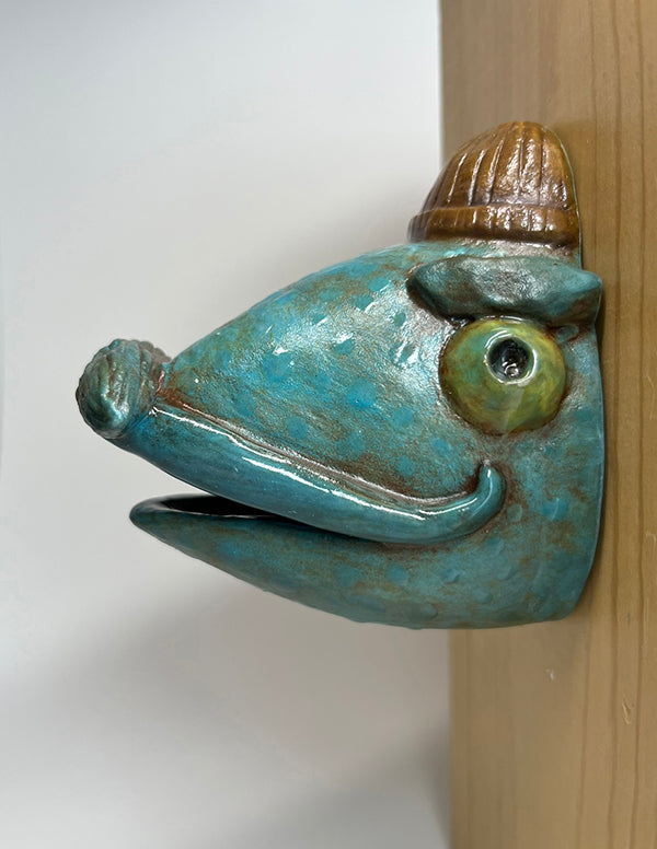 Gus fish-head wall-hanging with tan beanie and mustache