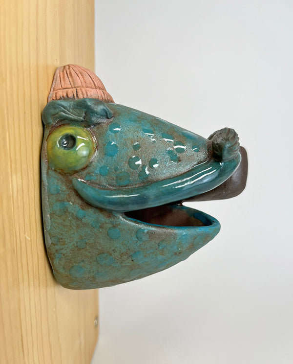 Marty fish-head wall-hanging with peach beanie and pipe