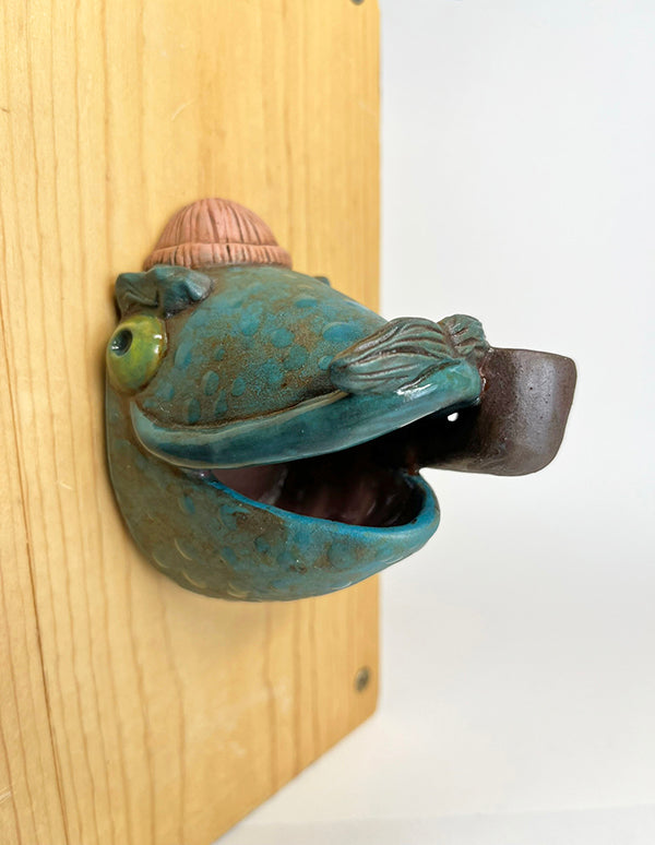 Marty fish-head wall-hanging with peach beanie and pipe