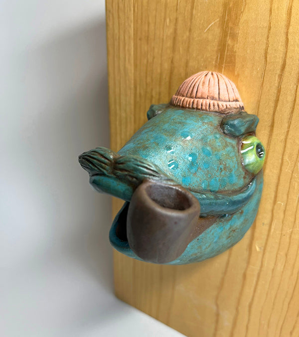 Marty fish-head wall-hanging with peach beanie and pipe