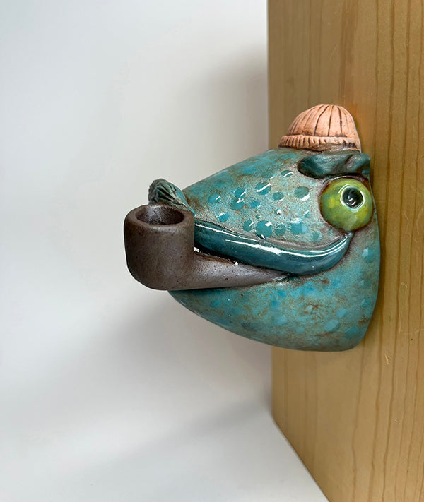 Marty fish-head wall-hanging with peach beanie and pipe