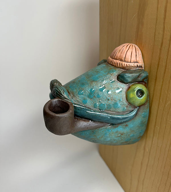 Marty fish-head wall-hanging with peach beanie and pipe