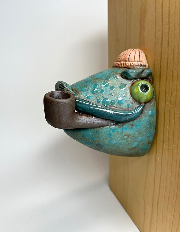 Marty fish-head wall-hanging with peach beanie and pipe