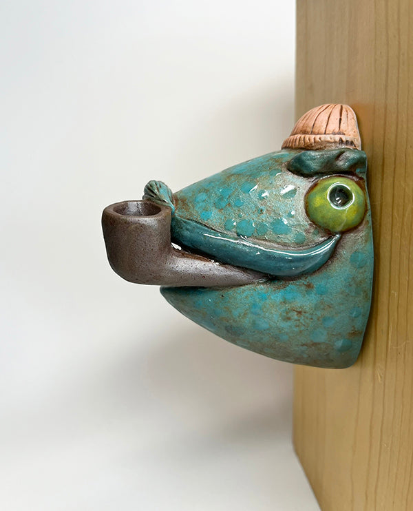 Marty fish-head wall-hanging with peach beanie and pipe