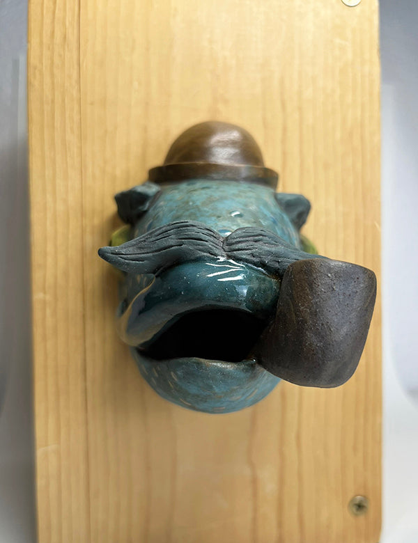 Herbert fish-head wall-hanging with bowler hat and pipe