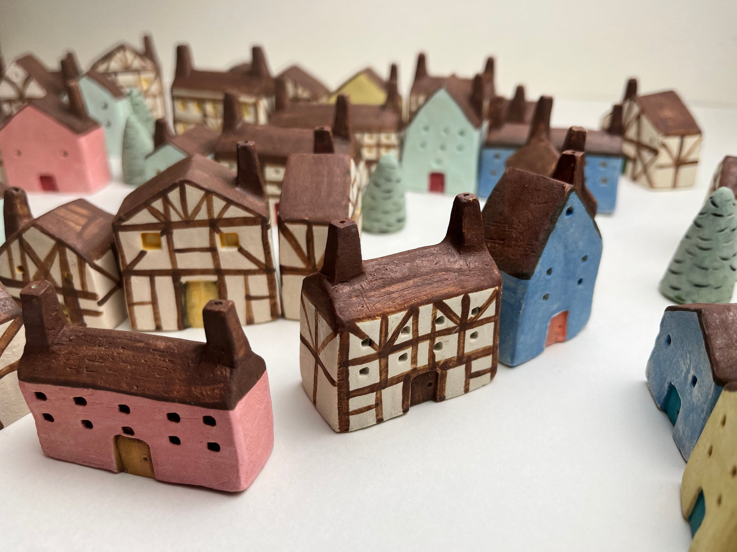 Tiny solid color earthenware houses