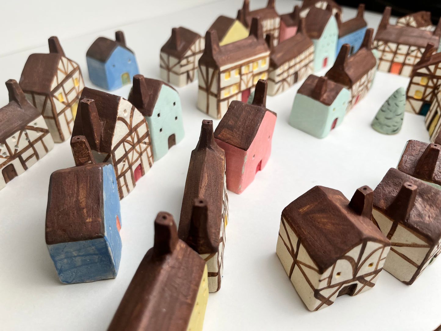 Tiny solid color earthenware houses