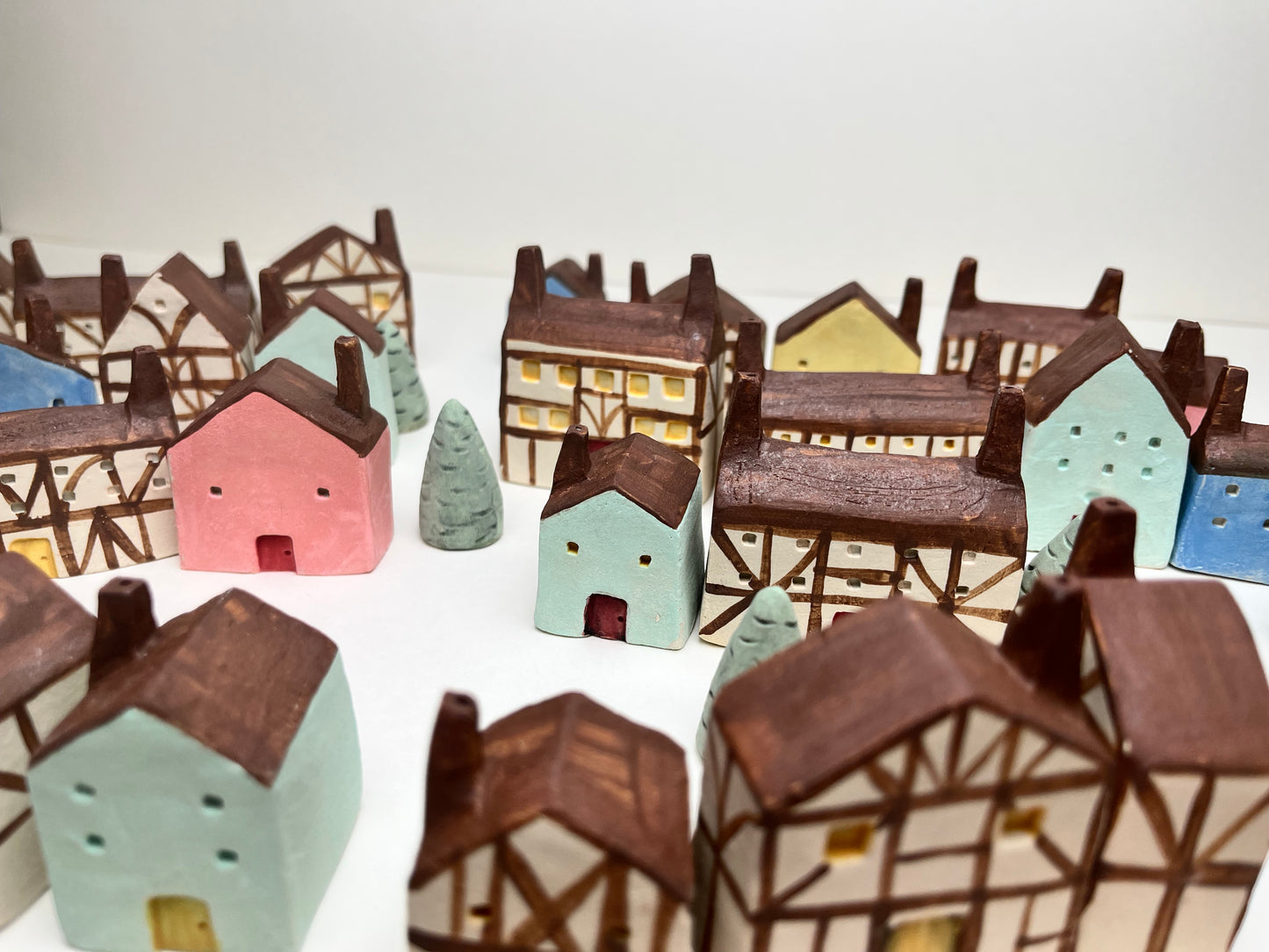 Tiny solid color earthenware houses