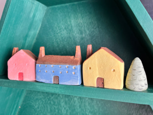 Tiny solid color earthenware houses