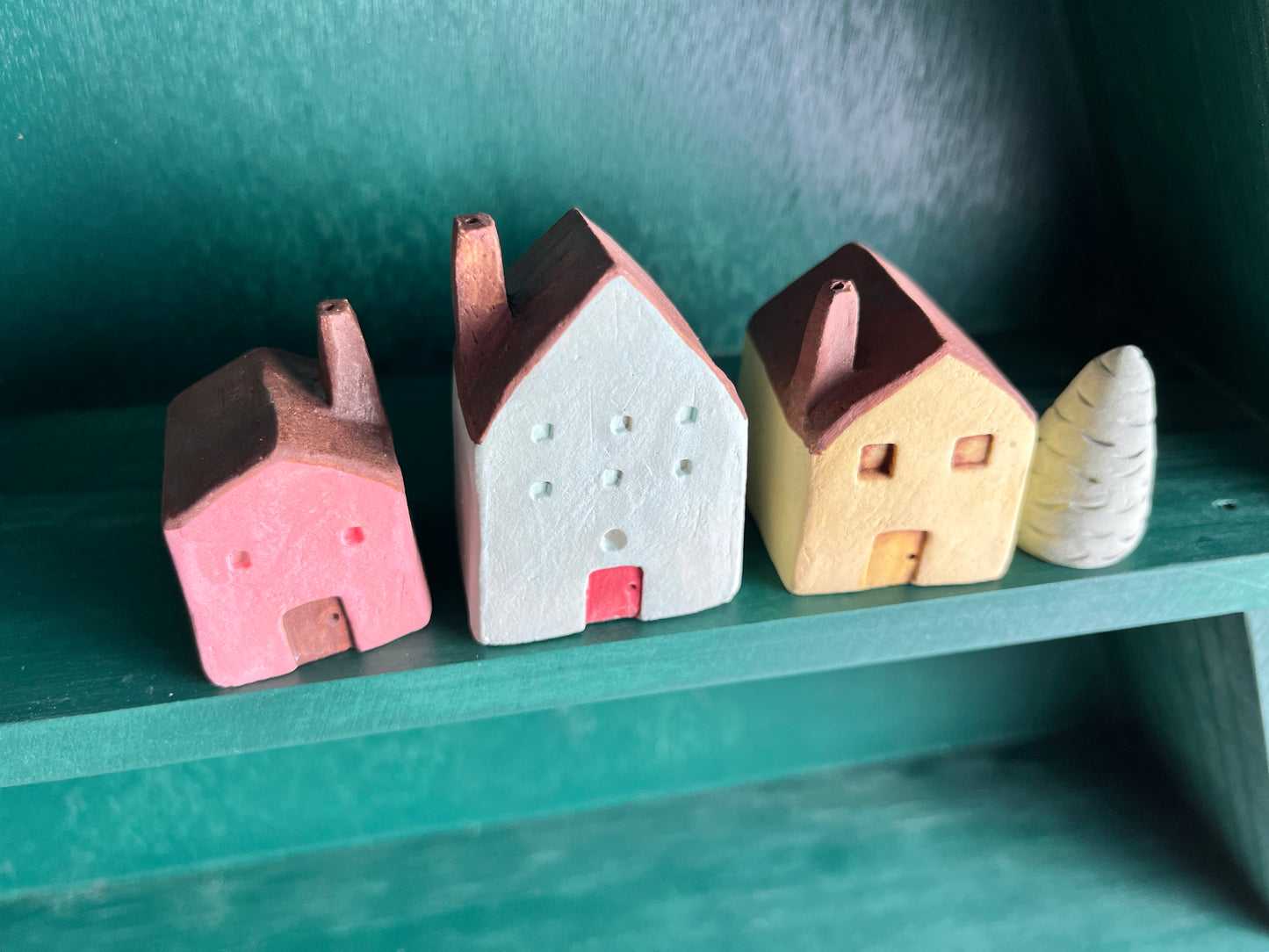 Tiny solid color earthenware houses