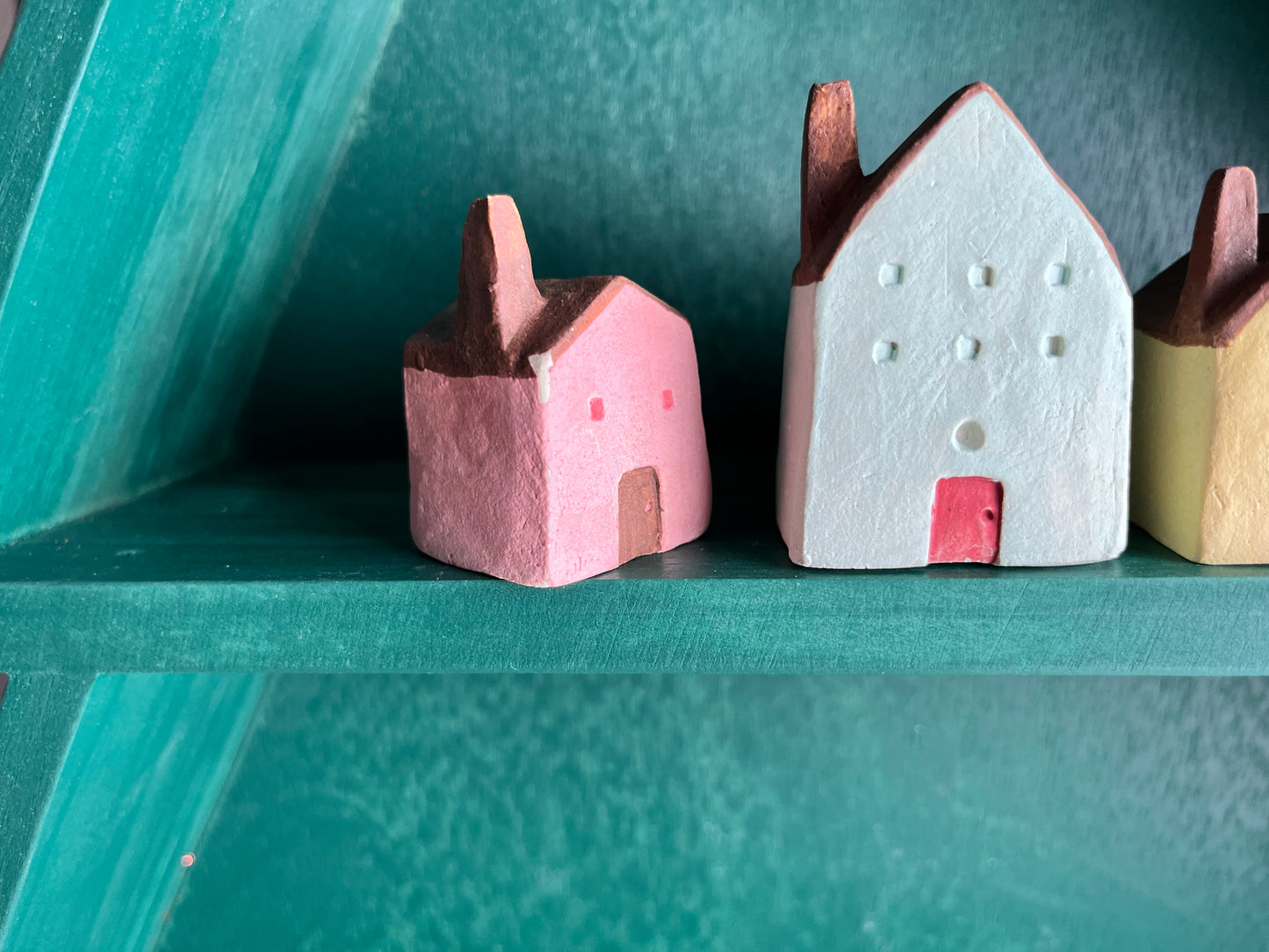 Tiny solid color earthenware houses