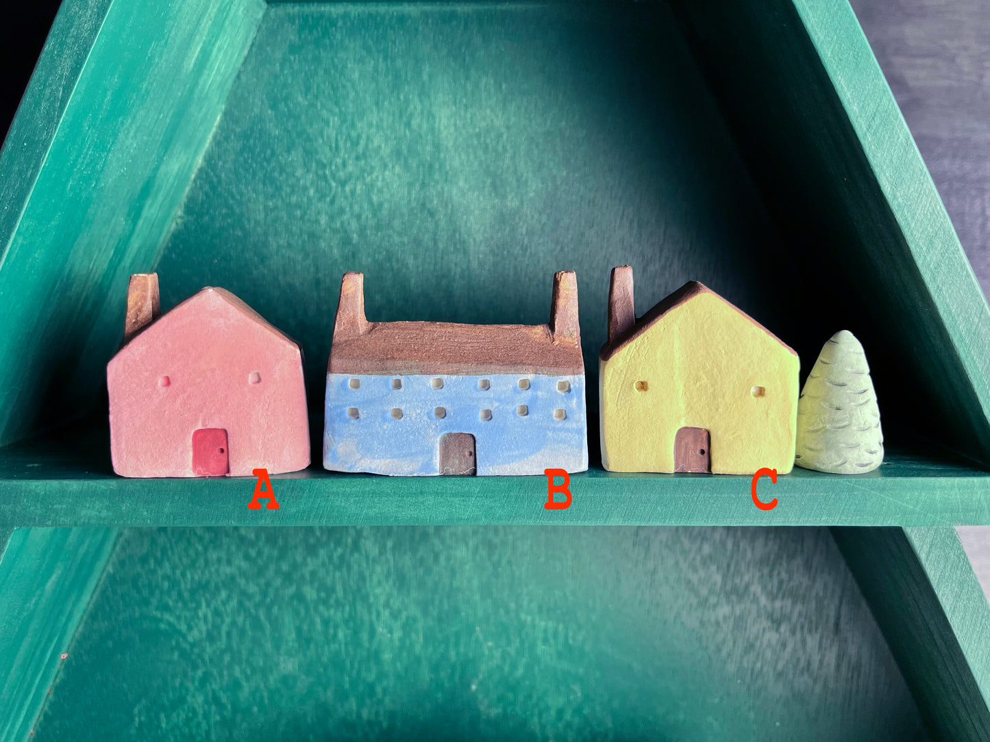 Tiny solid color earthenware houses