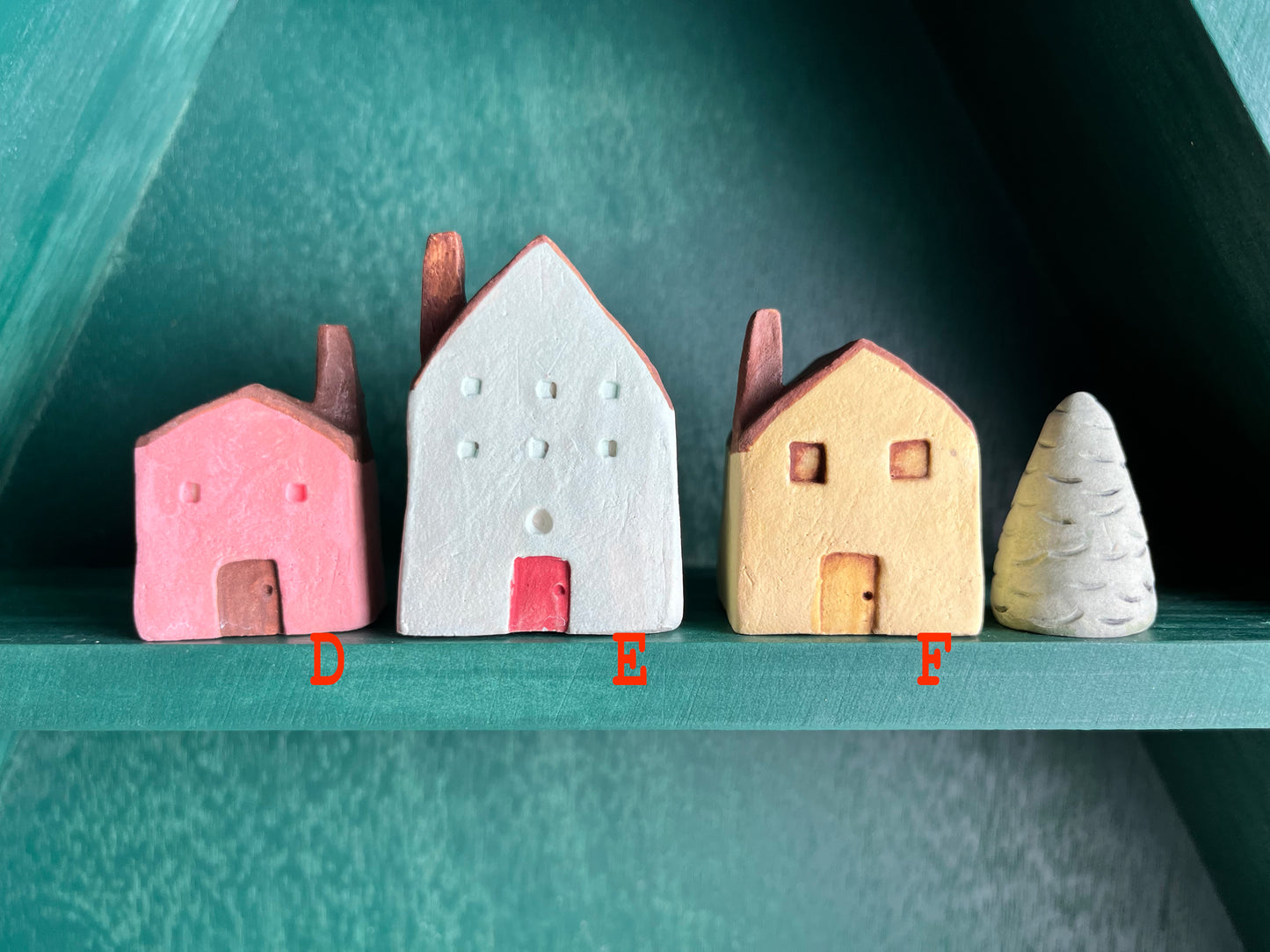 Tiny solid color earthenware houses